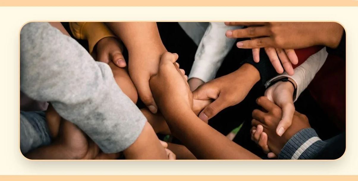 Children's hands interlocked together, a symbol of unity and belonging