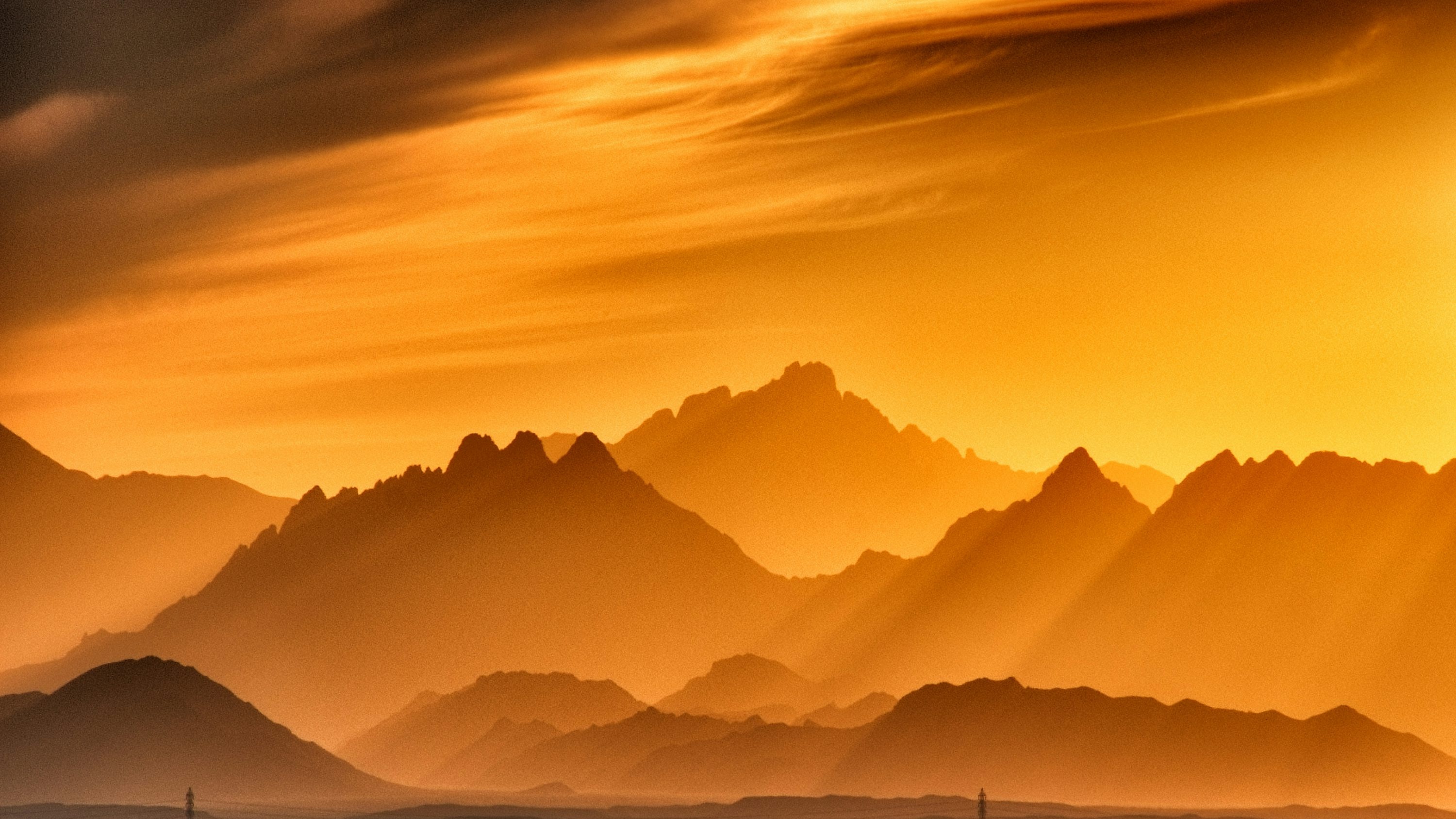 A vast ocean with mountains at golden hour, the possibility of connection